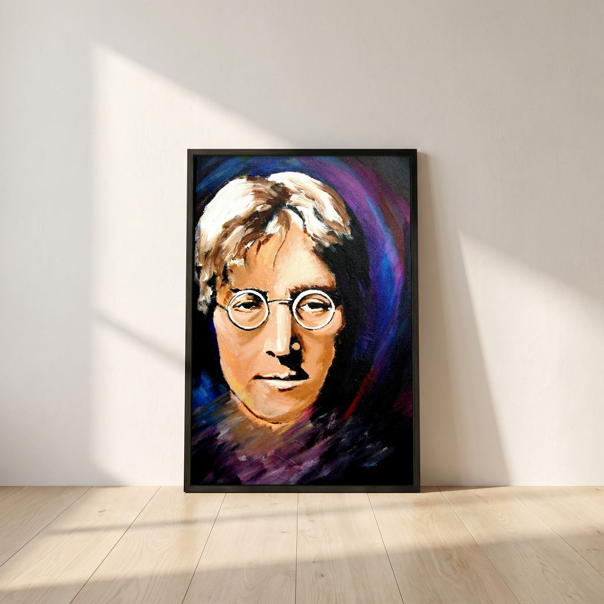 John Lennon Portrait framed print in a black frame leaning against a white plaster wall on oak floorboards in morning light