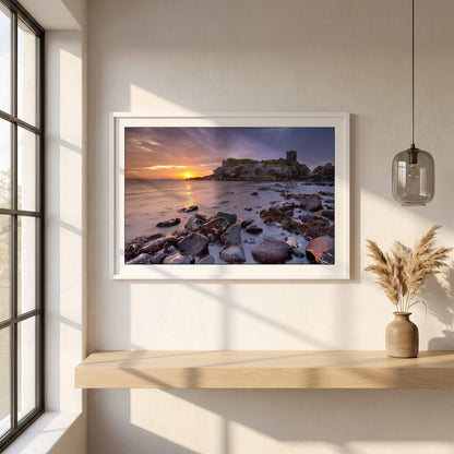 Kinbane Castle Ireland Photography framed print in a white frame on a plaster wall above an oak worktop in a bright Scandinavian kitchen