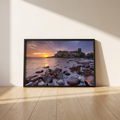 Kinbane Castle Ireland Photography framed print in a black frame leaning against a white plaster wall on oak floorboards in morning light