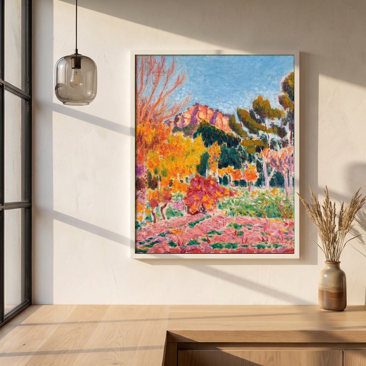 Landscape Cassis framed print in a white frame on a plaster wall above an oak worktop in a bright Scandinavian kitchen