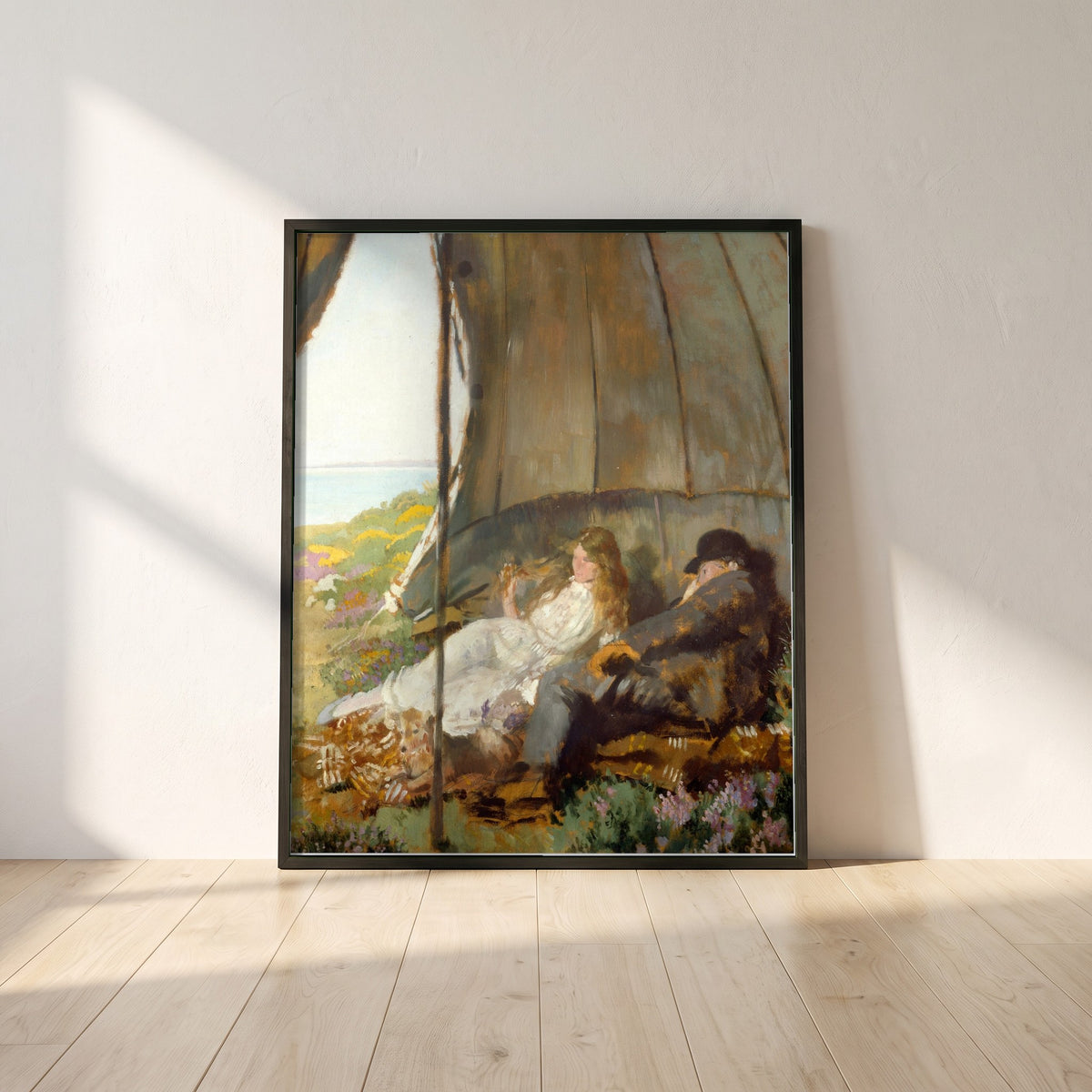 Looking at the Sea framed print in a black frame leaning against a white plaster wall on oak floorboards in morning light