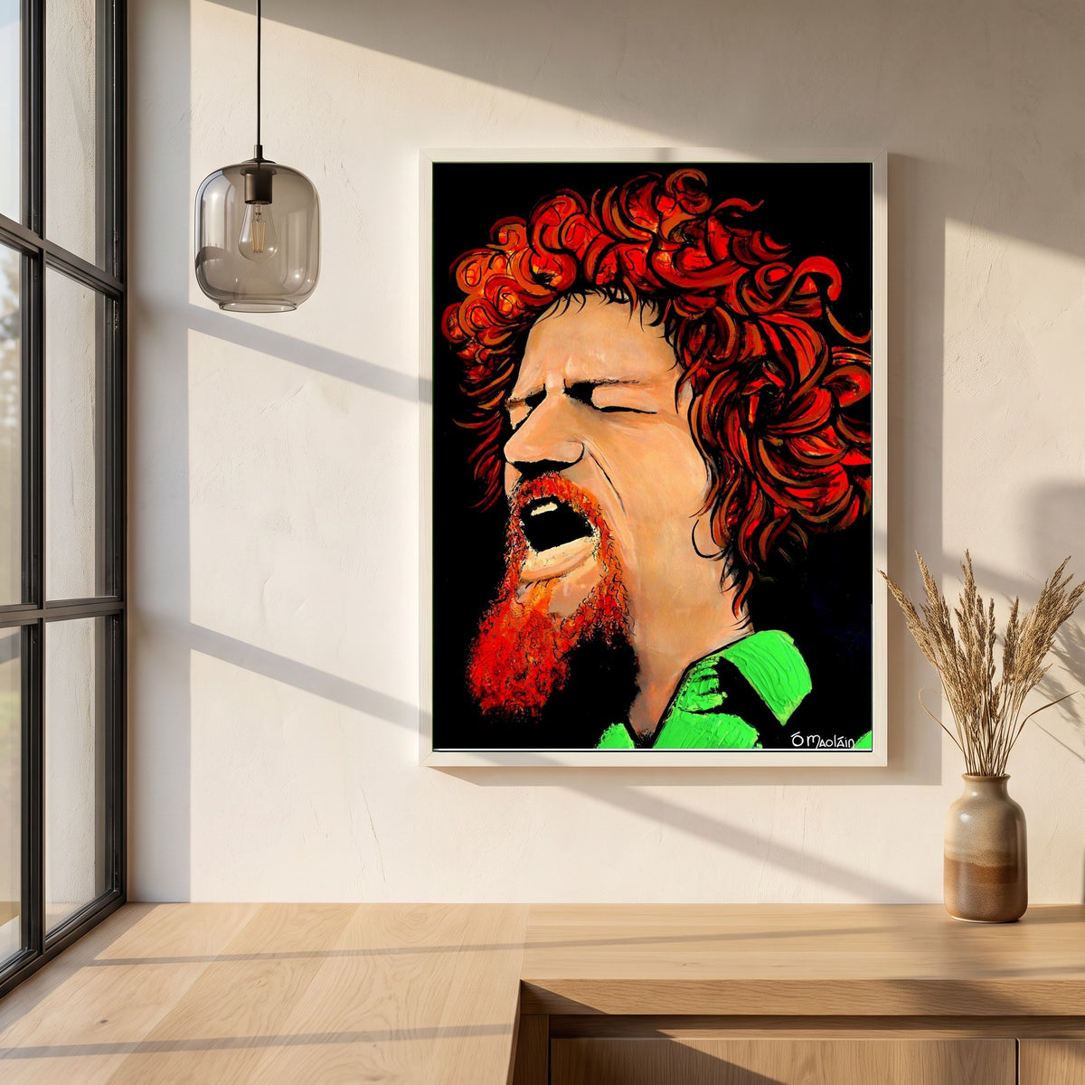 Luke Kelly framed print in a white frame on a plaster wall above an oak worktop in a bright Scandinavian kitchen