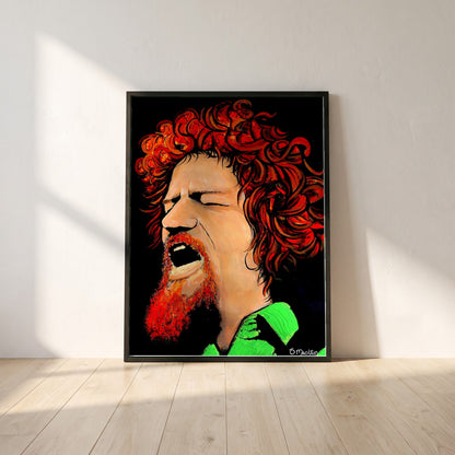 Luke Kelly framed print in a black frame leaning against a white plaster wall on oak floorboards in morning light