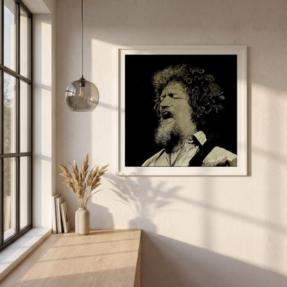 Luke Kelly framed print in a white frame on a plaster wall above an oak worktop in a bright Scandinavian kitchen