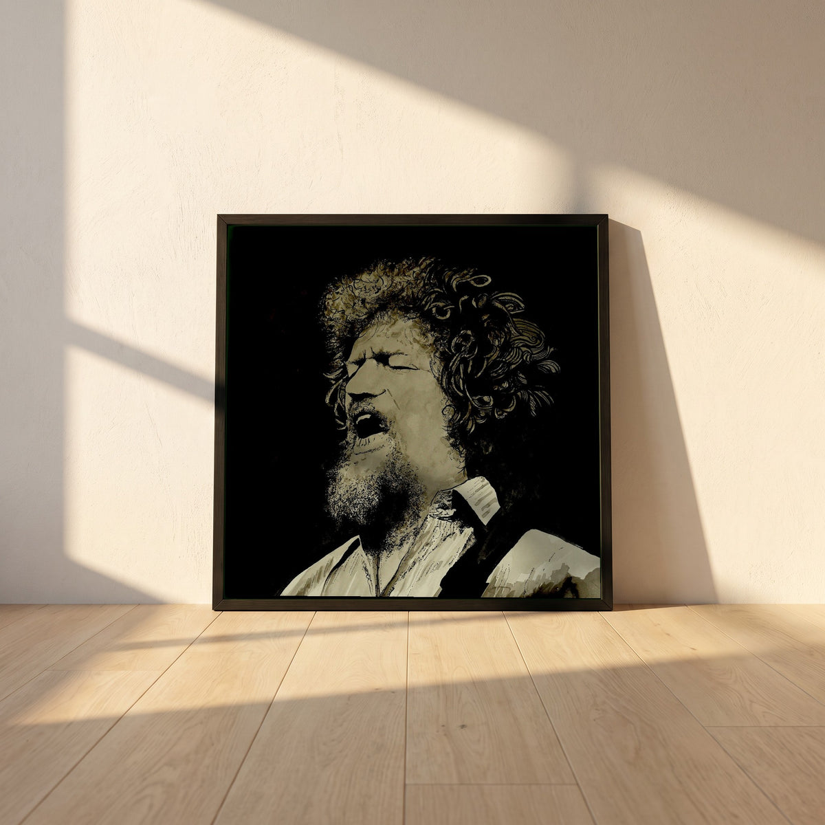 Luke Kelly framed print in a black frame leaning against a white plaster wall on oak floorboards in morning light