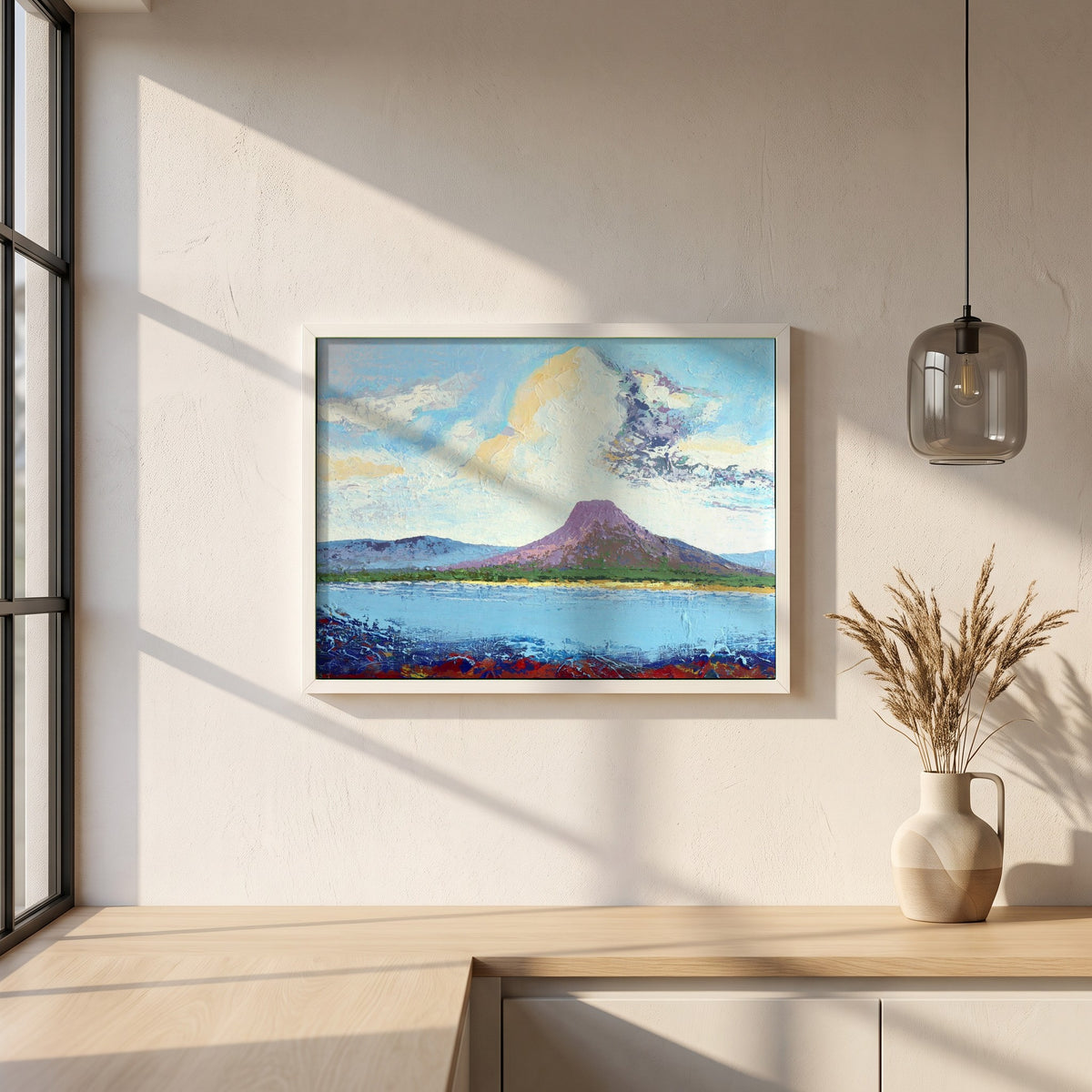 Lurig from the Shore framed print in a white frame on a plaster wall above an oak worktop in a bright Scandinavian kitchen