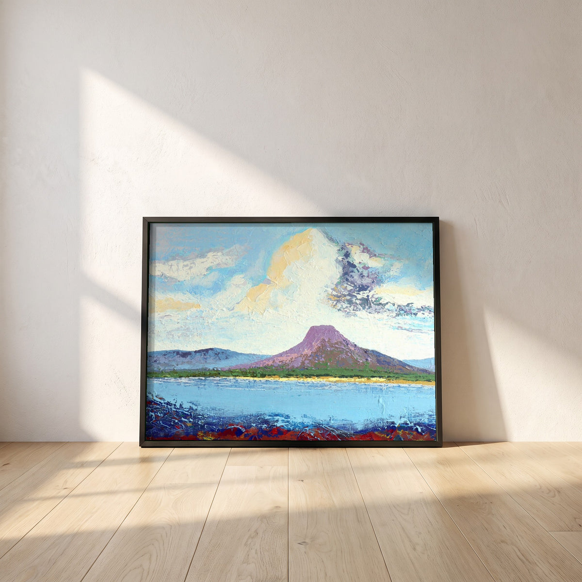 Lurig from the Shore framed print in a black frame leaning against a white plaster wall on oak floorboards in morning light