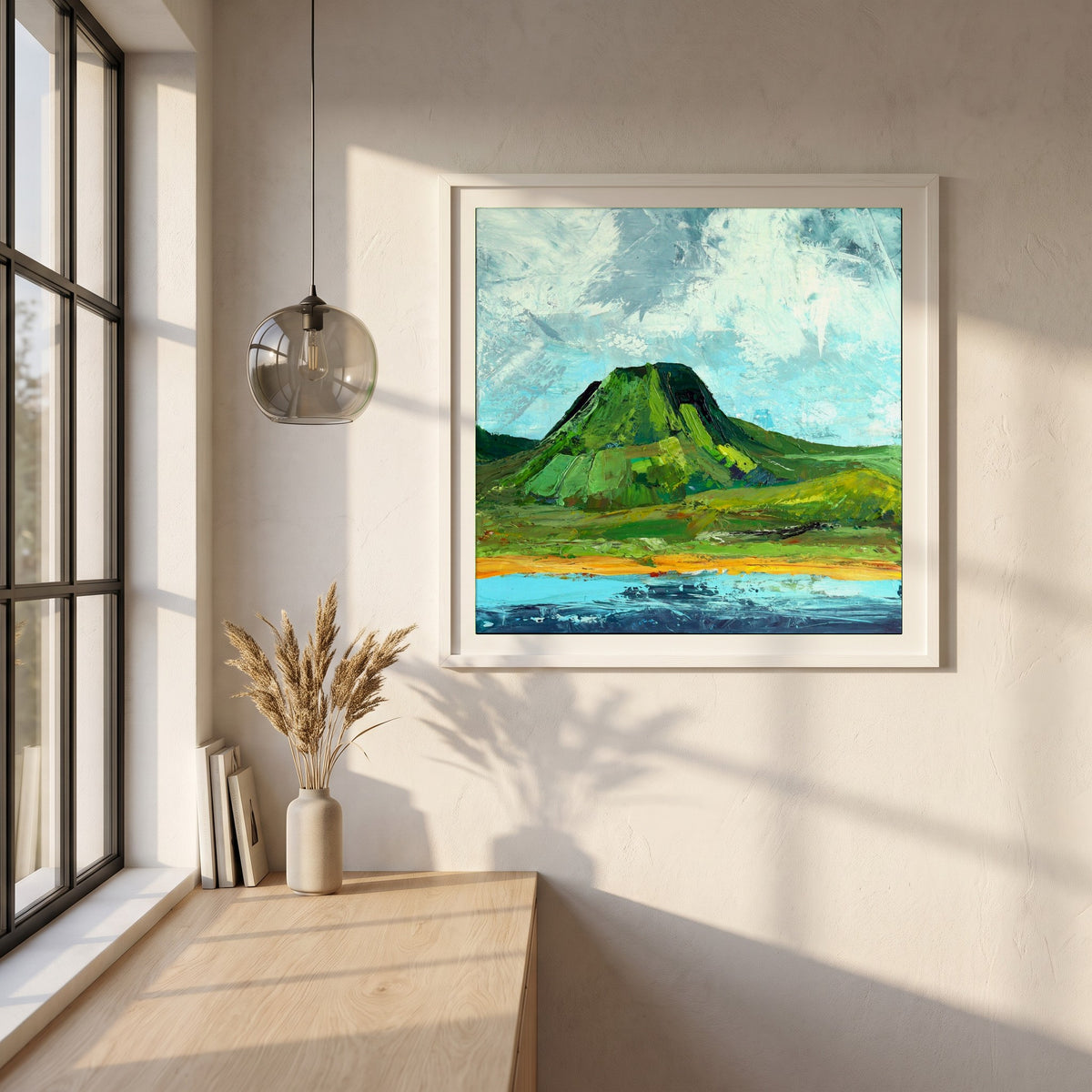 Lurig Mountain, Cushendall framed print in a white frame on a plaster wall above an oak worktop in a bright Scandinavian kitchen