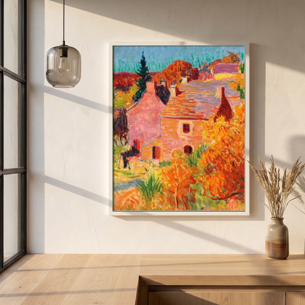 Maisons Rouges à Pont-Aven framed print in a white frame on a plaster wall above an oak worktop in a bright Scandinavian kitchen