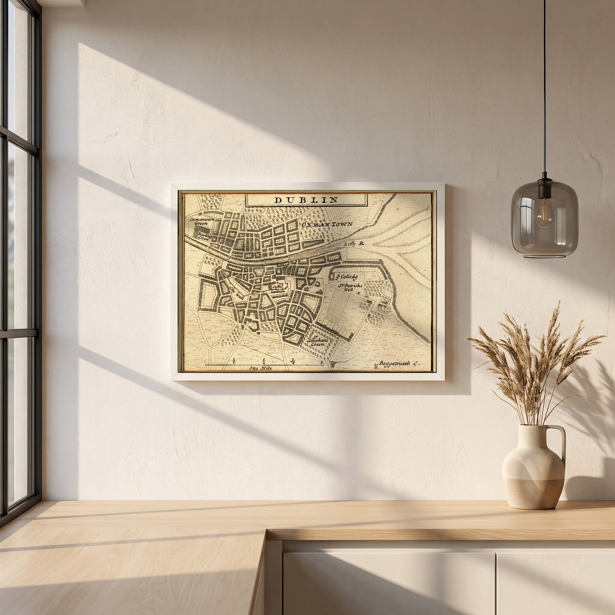 Map of Dublin City in 1714 framed print in a white frame on a plaster wall above an oak worktop in a bright Scandinavian kitchen