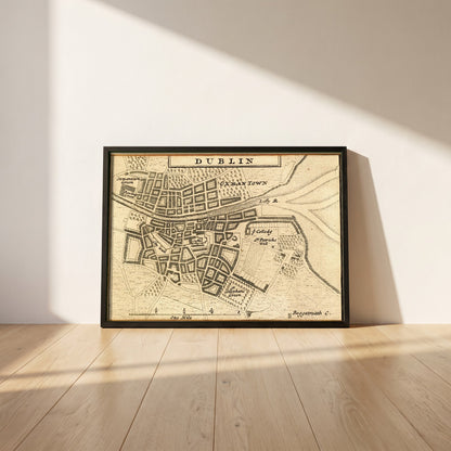 Map of Dublin City in 1714 framed print in a black frame leaning against a white plaster wall on oak floorboards in morning light