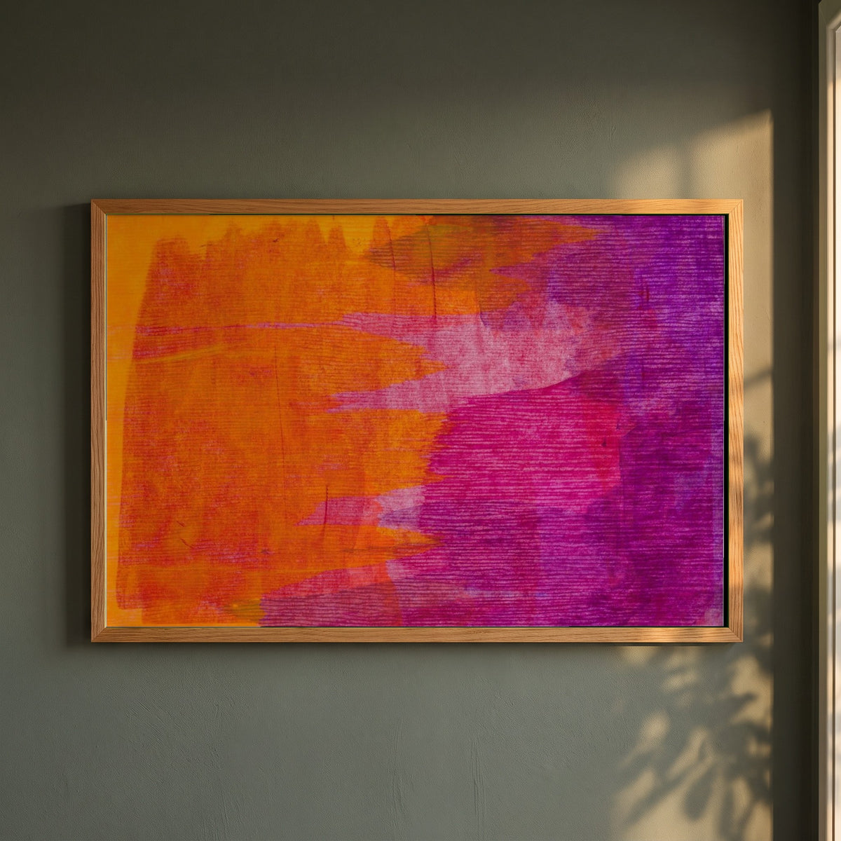 Minimalist Abstract Modern Style Orange & Purple framed print in a natural oak frame on a dark green wall beside a window, dappled plant shadow