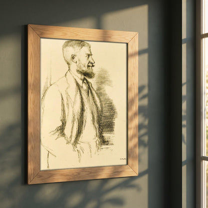Mr George Bernard Shaw (1897) by William Rothenstein framed print in a natural oak frame on a dark green wall beside a window, dappled plant shadow