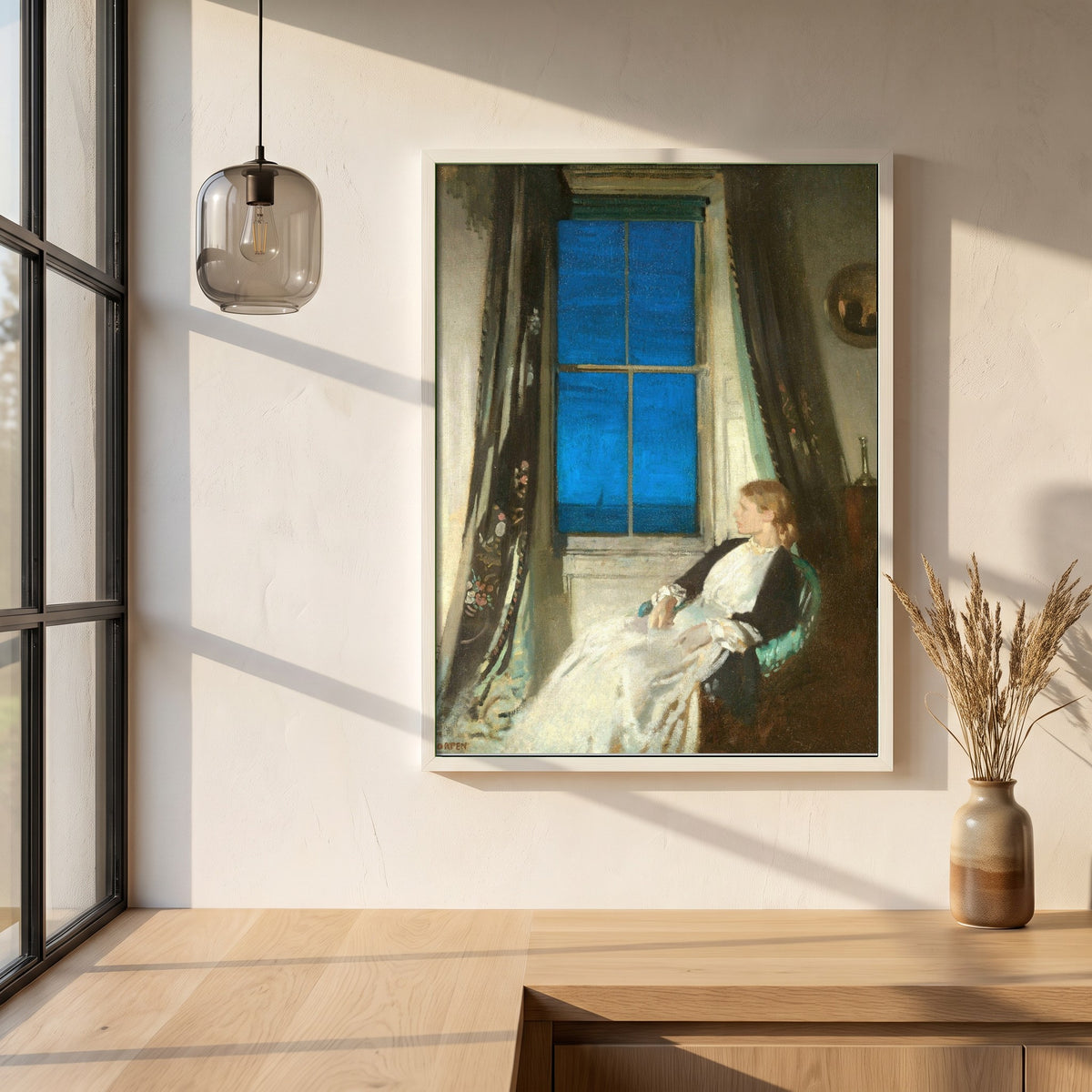 Night framed print in a white frame on a plaster wall above an oak worktop in a bright Scandinavian kitchen