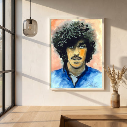 Phil Lynott Thin Lizzy framed print in a white frame on a plaster wall above an oak worktop in a bright Scandinavian kitchen
