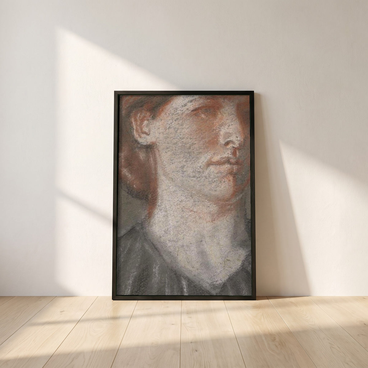 Portrait of Grace framed print in a black frame leaning against a white plaster wall on oak floorboards in morning light