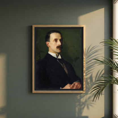 Portrait of Sir Hugh Lane framed print in a natural oak frame on a dark green wall beside a window, dappled plant shadow