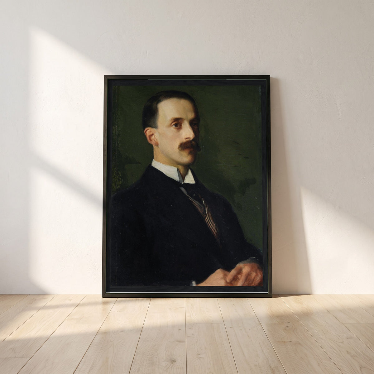 Portrait of Sir Hugh Lane framed print in a black frame leaning against a white plaster wall on oak floorboards in morning light
