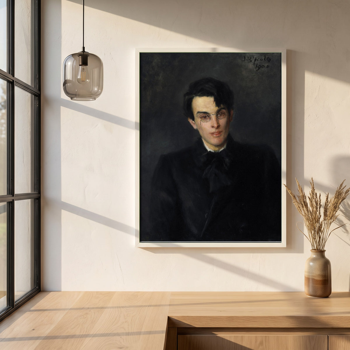 Portrait of W.B. Yeats framed print in a white frame on a plaster wall above an oak worktop in a bright Scandinavian kitchen