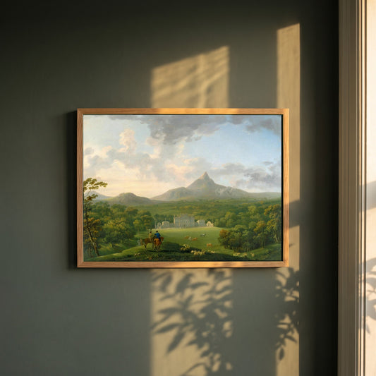 Powerscourt framed print in a natural oak frame on a dark green wall beside a window, dappled plant shadow