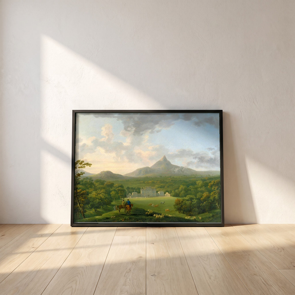 Powerscourt framed print in a black frame leaning against a white plaster wall on oak floorboards in morning light