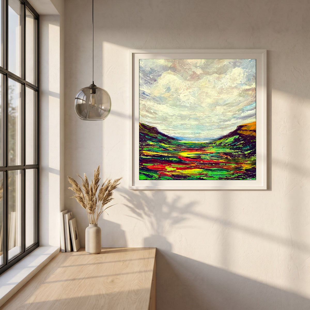 Glenariff framed print in a white frame on a plaster wall above an oak worktop in a bright Scandinavian kitchen