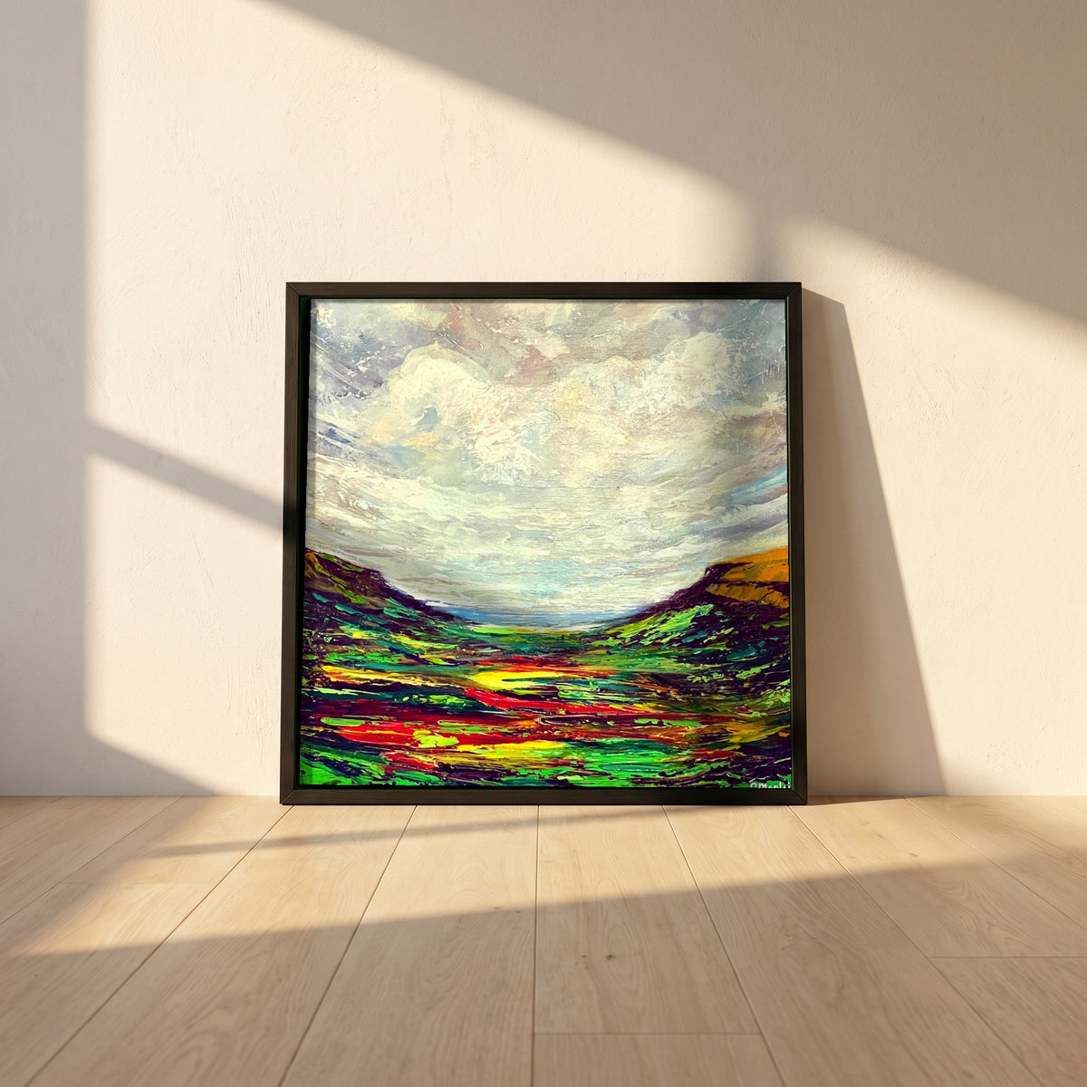 Glenariff framed print in a black frame leaning against a white plaster wall on oak floorboards in morning light