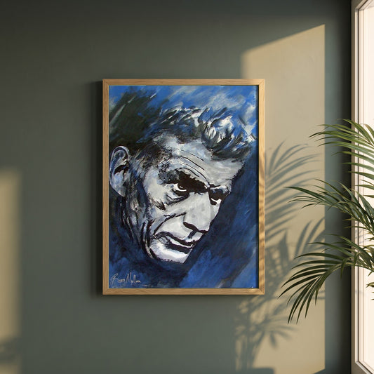 Samuel Beckett framed print in a natural oak frame on a dark green wall beside a window, dappled plant shadow