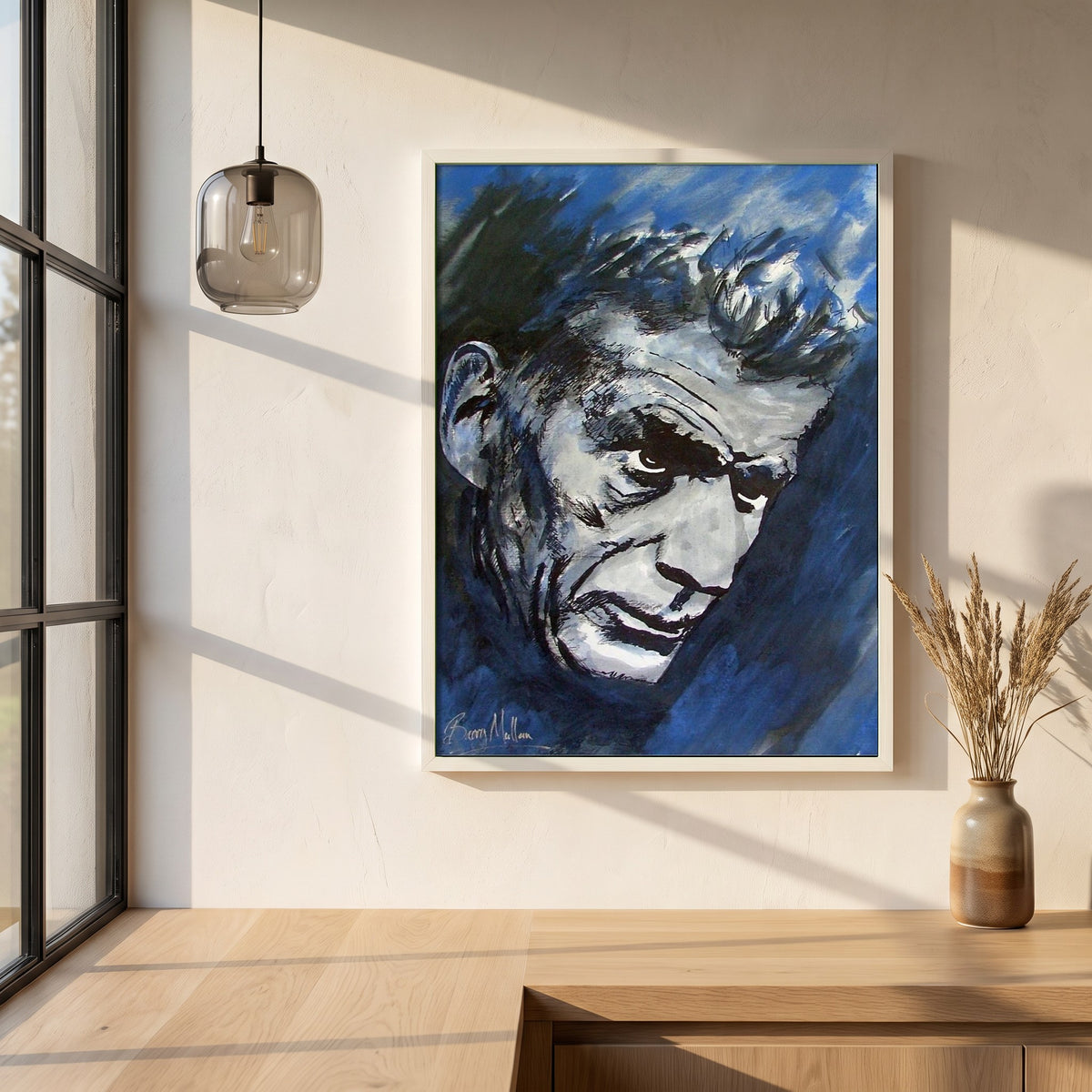 Samuel Beckett framed print in a white frame on a plaster wall above an oak worktop in a bright Scandinavian kitchen