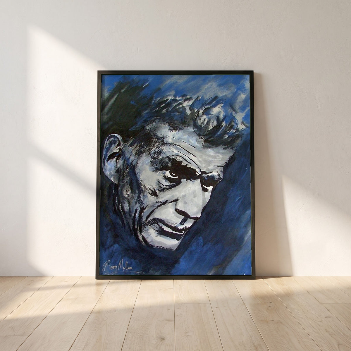 Samuel Beckett framed print in a black frame leaning against a white plaster wall on oak floorboards in morning light