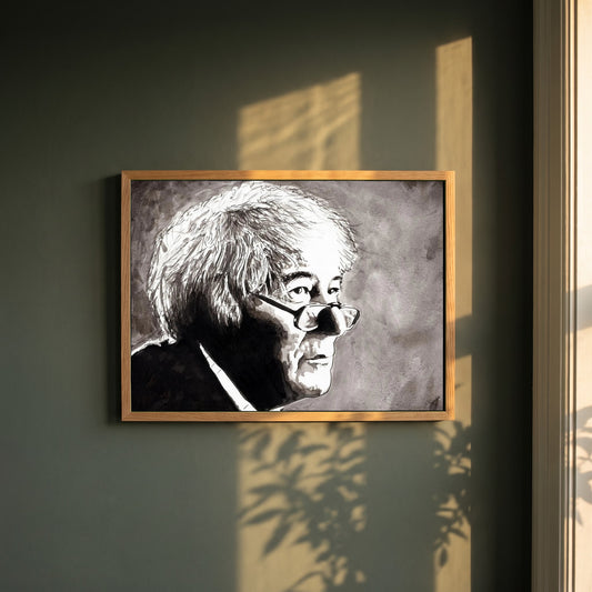 Seamus Heaney framed print in a natural oak frame on a dark green wall beside a window, dappled plant shadow