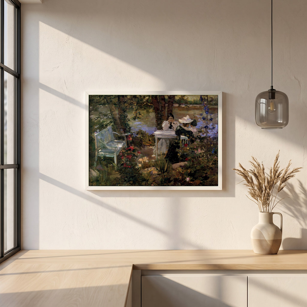 A Garden in France framed print in a white frame on a plaster wall above an oak worktop in a bright Scandinavian kitchen