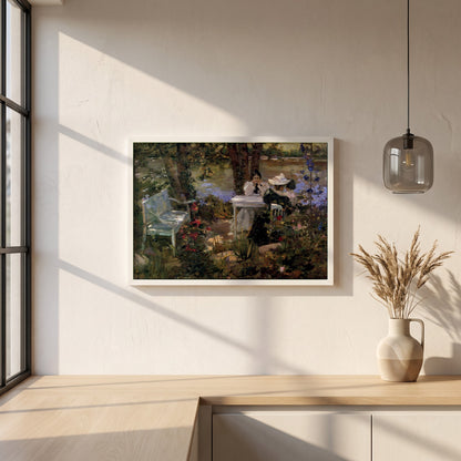 A Garden in France framed print in a white frame on a plaster wall above an oak worktop in a bright Scandinavian kitchen
