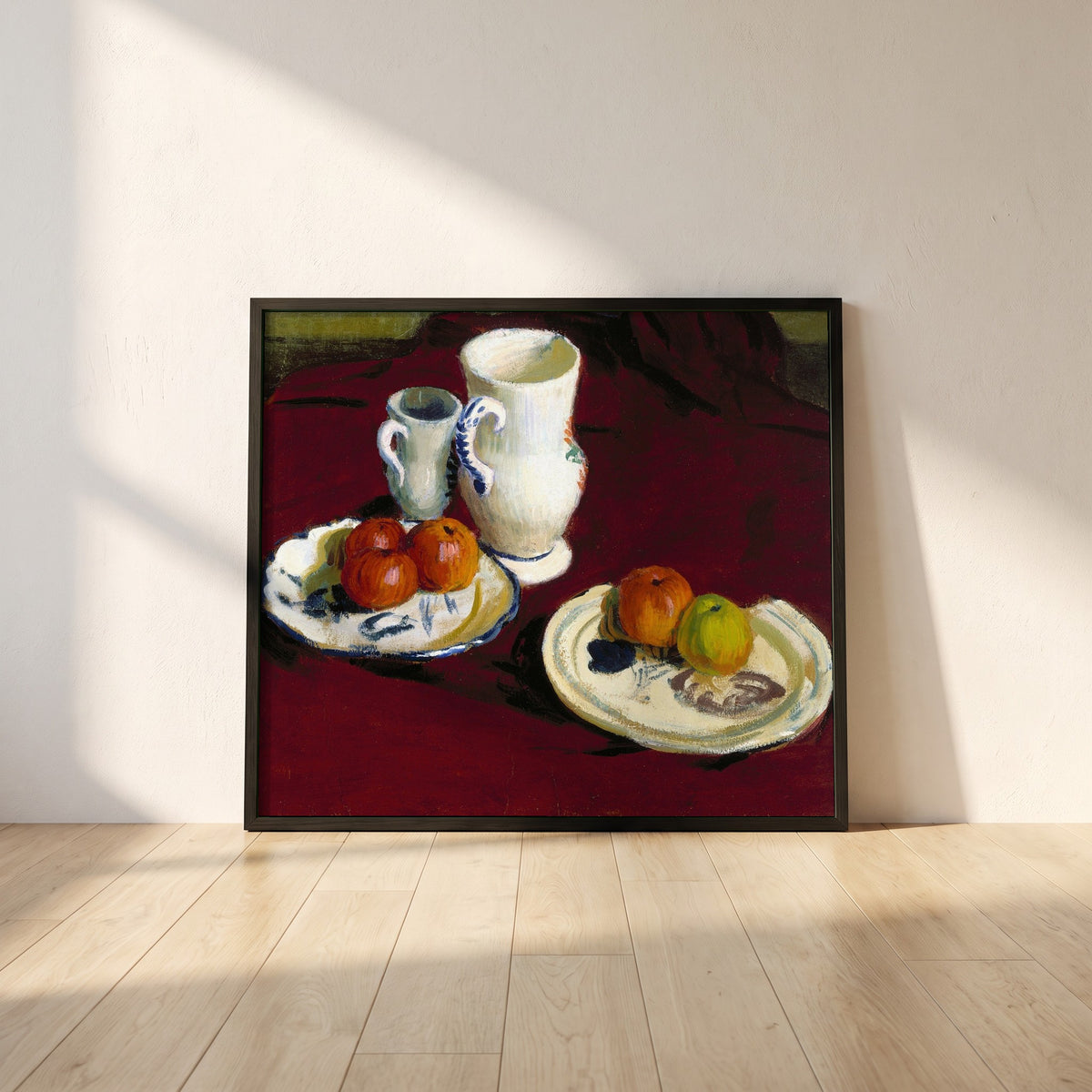 Apples and Breton Pots framed print in a black frame leaning against a white plaster wall on oak floorboards in morning light