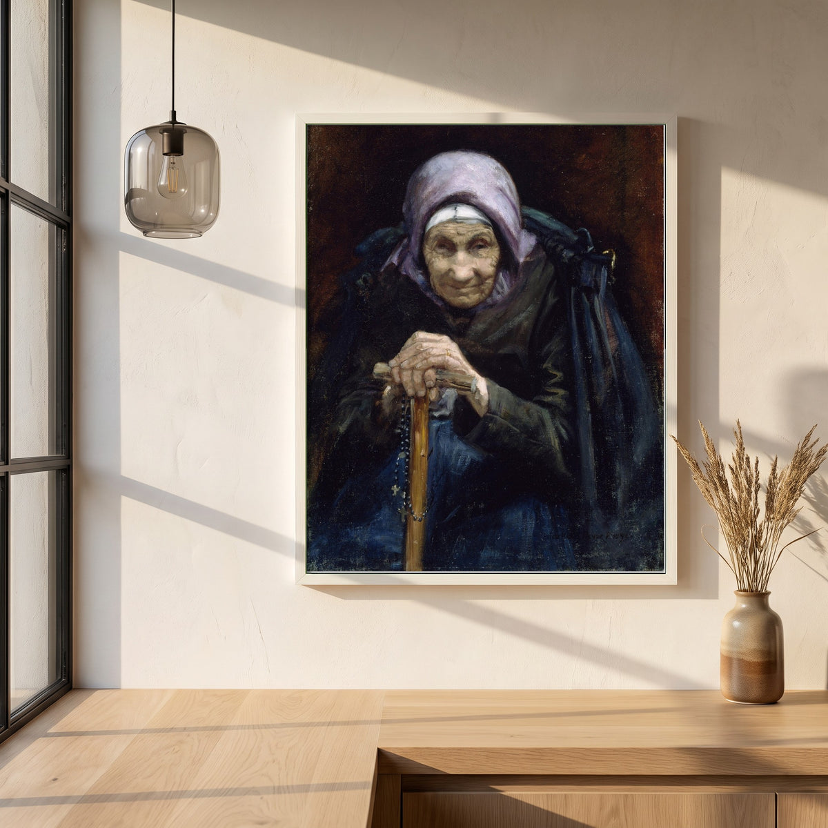 The Fisherman's Mother framed print in a white frame on a plaster wall above an oak worktop in a bright Scandinavian kitchen