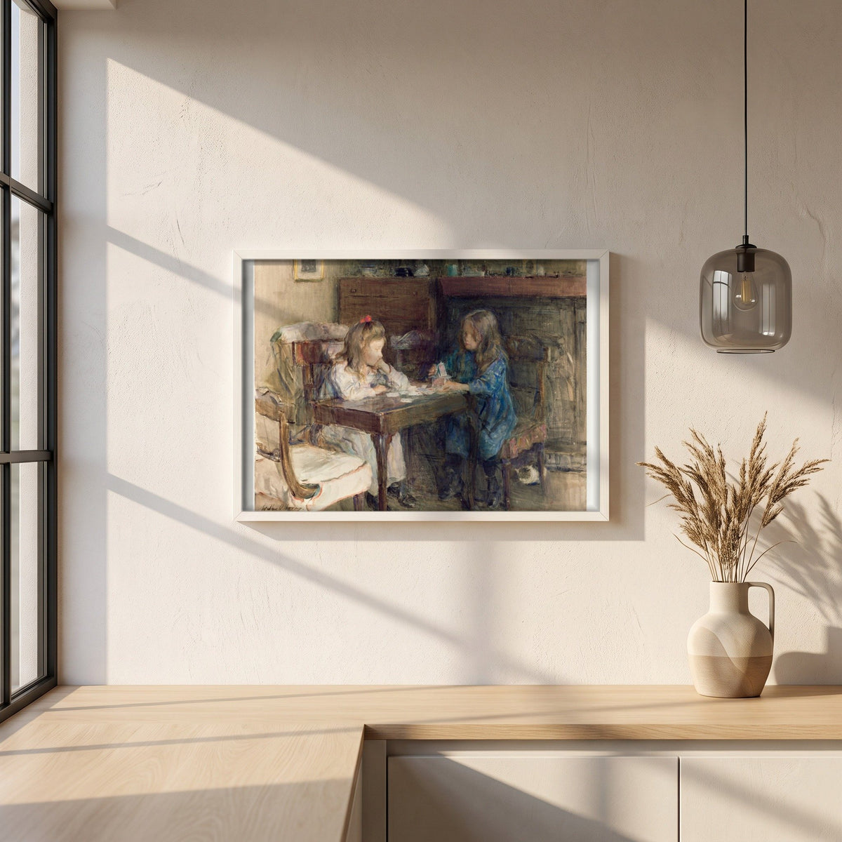 The House Builders framed print in a white frame on a plaster wall above an oak worktop in a bright Scandinavian kitchen