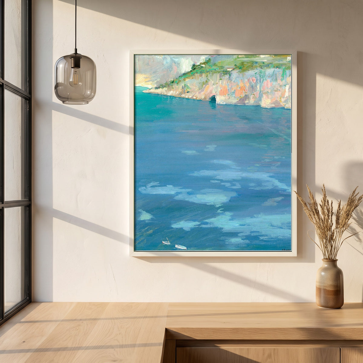 The Little White Boats, Cap Ferrat framed print in a white frame on a plaster wall above an oak worktop in a bright Scandinavian kitchen