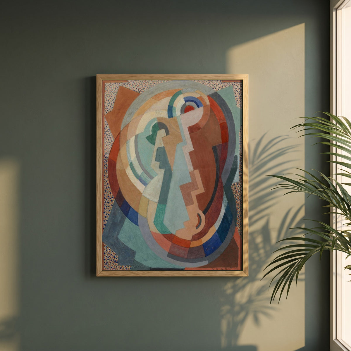 The Virgin and Child framed print in a natural oak frame on a dark green wall beside a window, dappled plant shadow