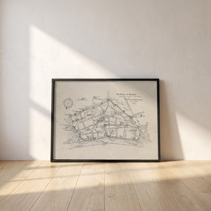 The Walls of Dublin framed print in a black frame leaning against a white plaster wall on oak floorboards in morning light