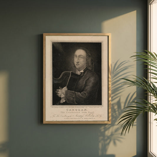 Turlough O'Carolan framed print in a natural oak frame on a dark green wall beside a window, dappled plant shadow