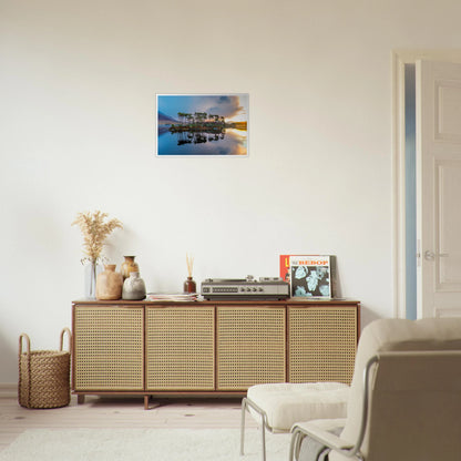 Twelve Pines Connemara lake photo print above a rattan sideboard with a record player