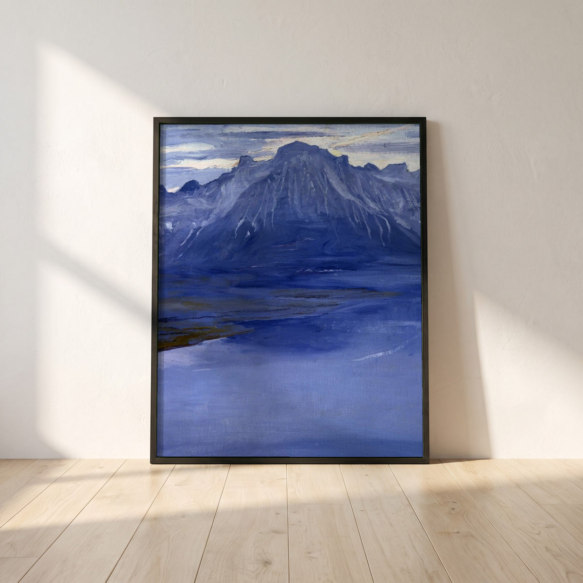 Twilight, Lake Geneva framed print in a black frame leaning against a white plaster wall on oak floorboards in morning light